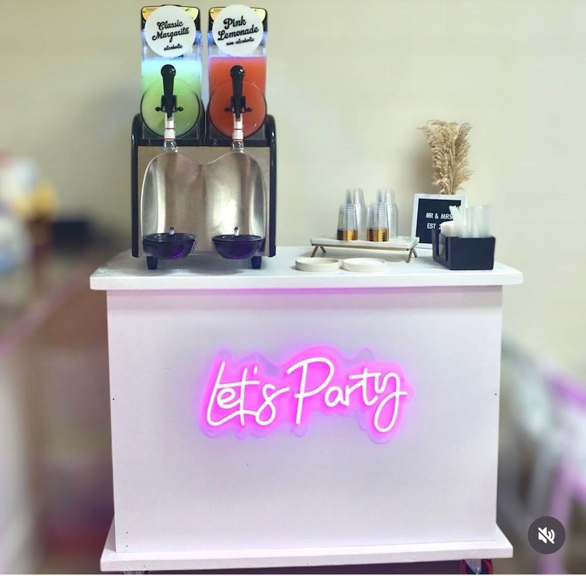 Wedding reception slushy cart with Let's Party neon sign