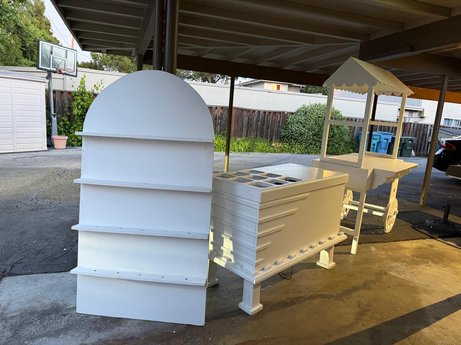 All three pieces together: arched display, honeycomb table, and vendor cart