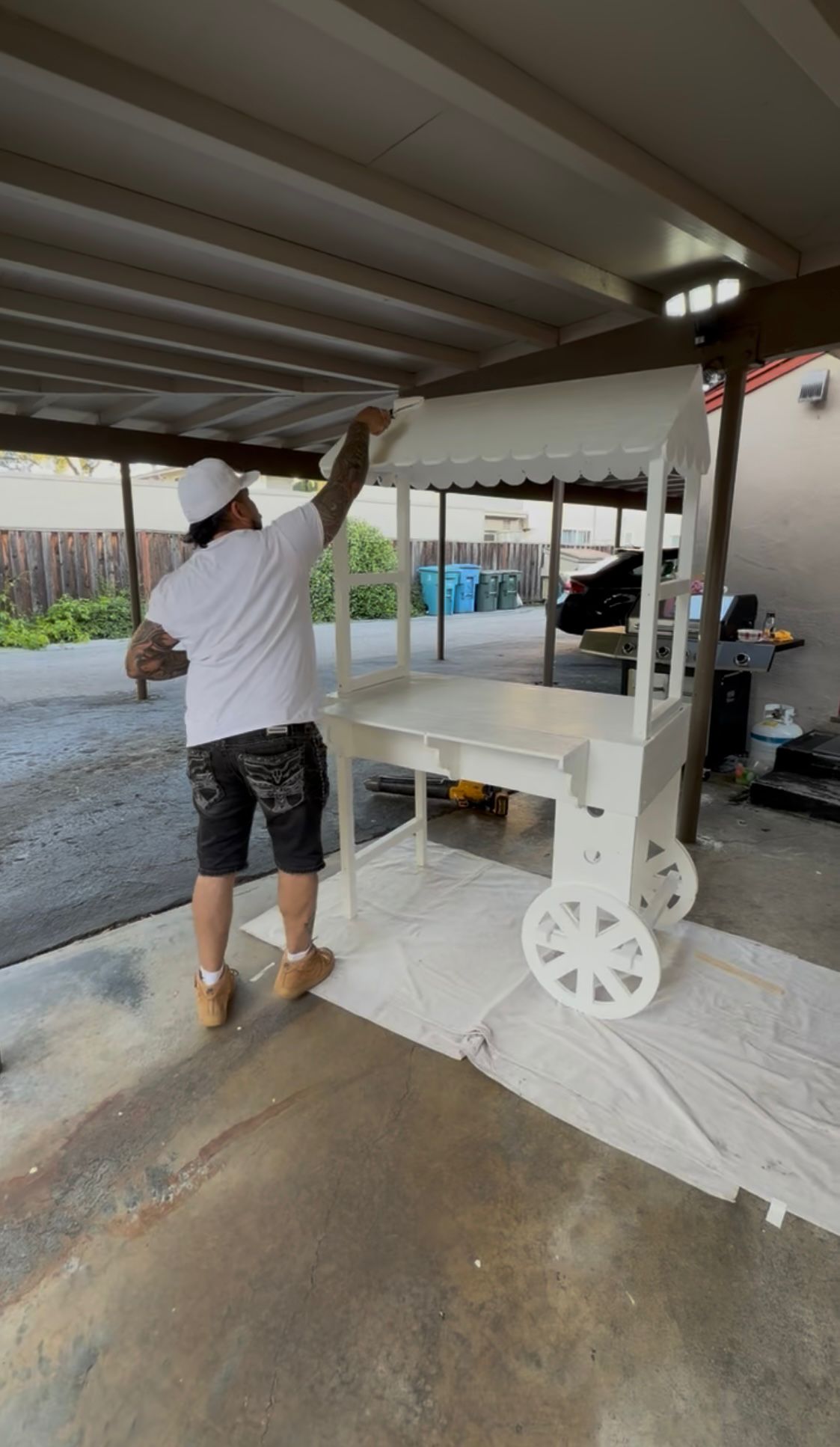 Oscar painting a freshly built cart in his workshop